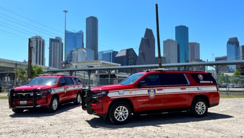 new supervisor trucks parked with high rise buildings in background